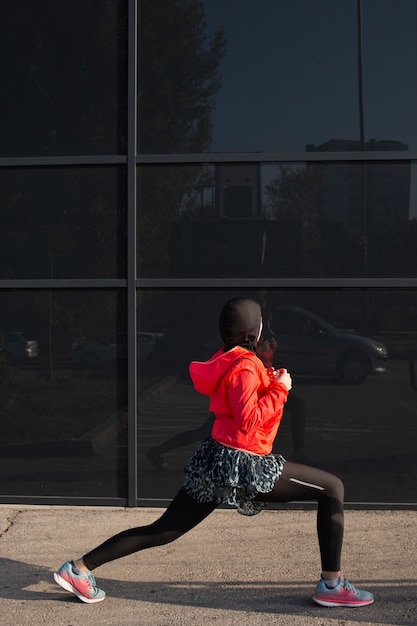 Free photo side view of woman stretching