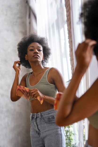 Side view woman  styling afro hair