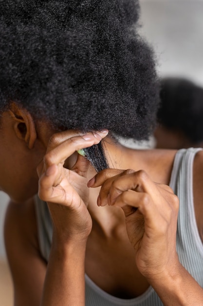 Side view woman styling afro hair