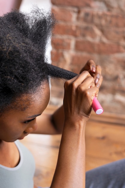 Side view woman styling curly hair