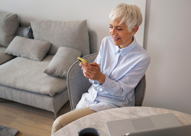 Side view woman taking a break with smartphone