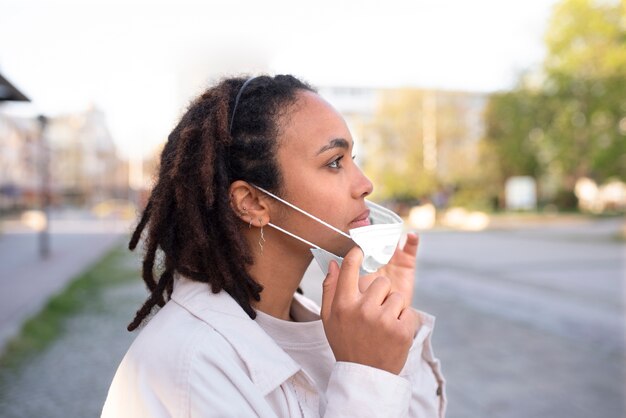 Side view woman taking mask off