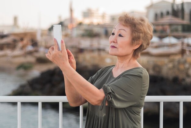 Side view woman taking photos