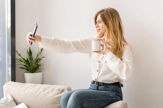 Side view woman taking selfie