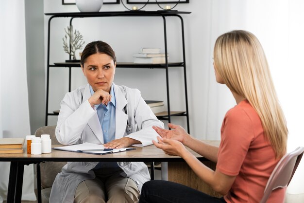 Side view woman talking to doctor