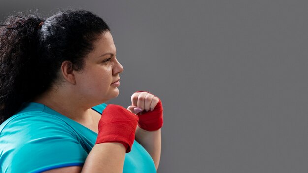 Side view woman training at gym