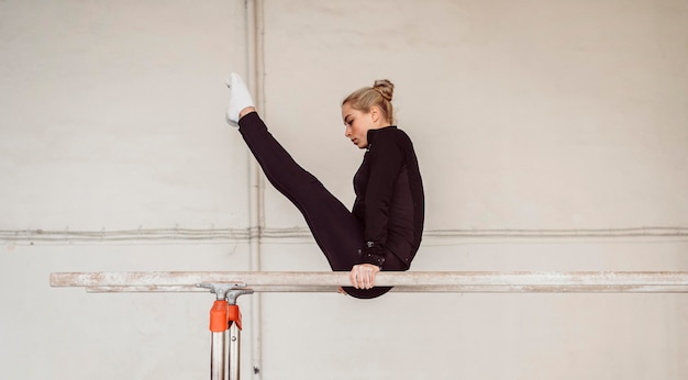 Side view woman training for gymnastics championship