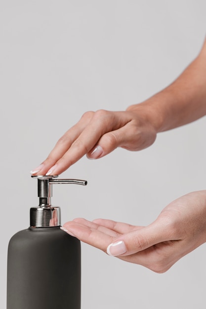 Side view woman using liquid soap