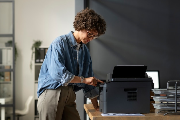 Side view woman using printer