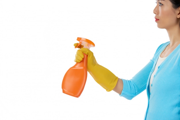 Free photo side view of woman using spray cleaner against  white background copyspace