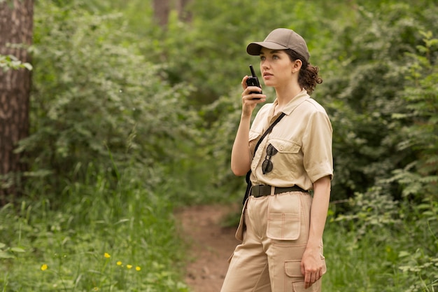 Side view woman using walkie talkie