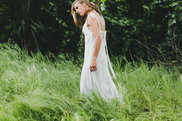 Side view woman walking in field