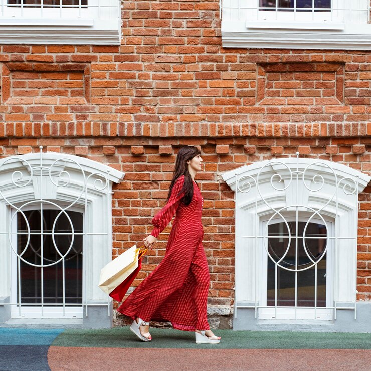 Free Photo side view of woman walking with lots of shopping bags