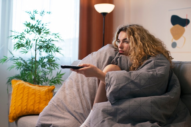 Side view woman watching news on tv