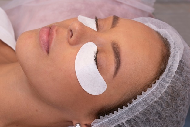 side view woman wearing eye patches