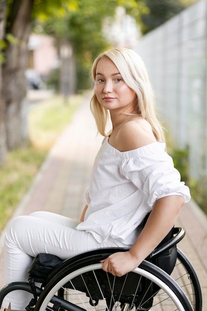 Side view of woman in wheelchair outdoors