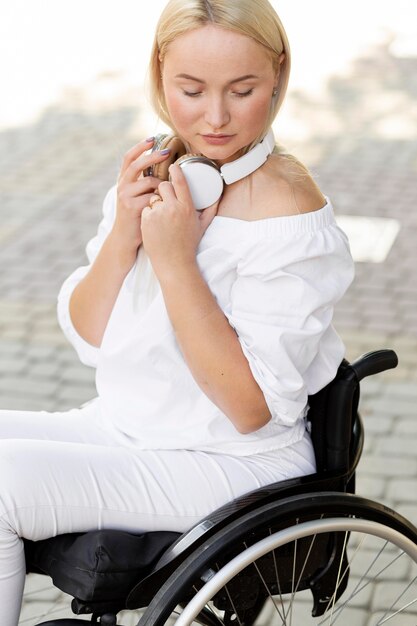 Side view of woman in wheelchair with headphones