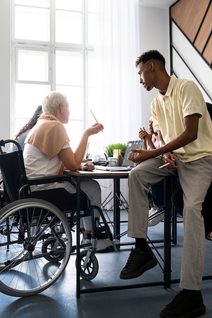 Side view woman in wheelchair at work