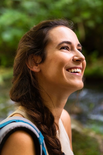 Side view of woman with backpack on adventure in nature