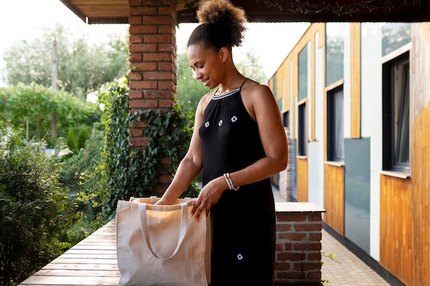 Free photo side view woman with bag outdoors