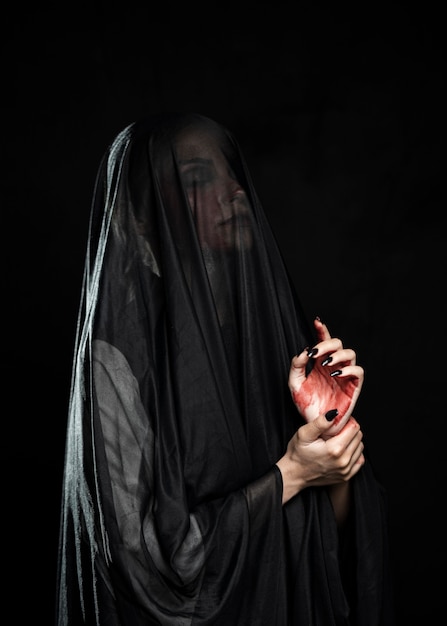 Free photo side view of woman with black veil