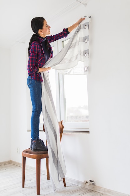 Free photo side view woman with curtain