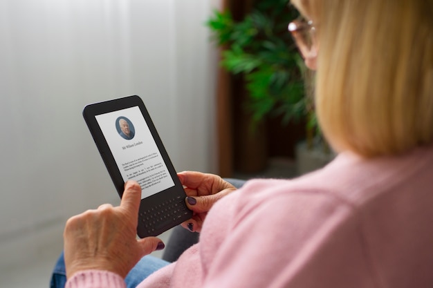 Side view woman with ebook reader