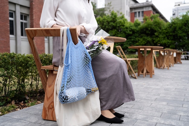 Free photo side view woman with fabric bag