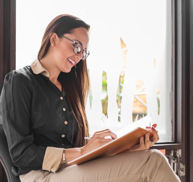 Side view woman with glasses checking statistics 