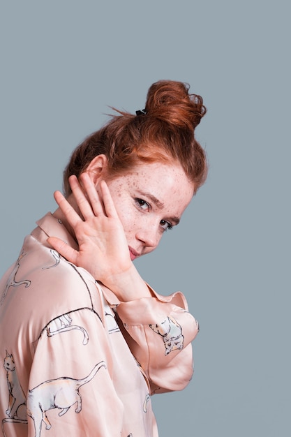 Side view woman with hair bun posing