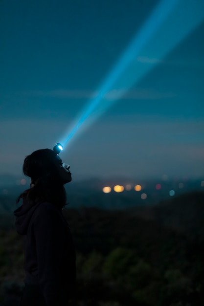 Side view woman with head lantern