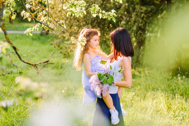 Side view of a woman with her daughter in park