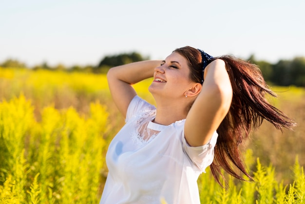 Side view of a woman with her hand in hair