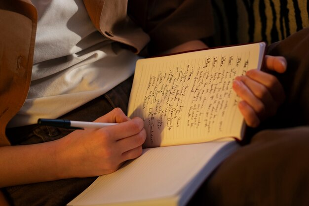 Side view woman with journal at home