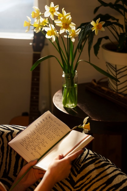 Side view woman with journal at home