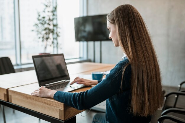 Side view of woman with laptop preparing for a meeting