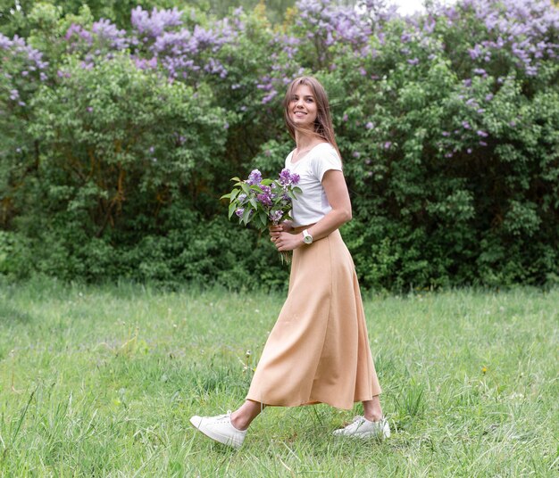 ライラック色の花を持つサイドビュー女性