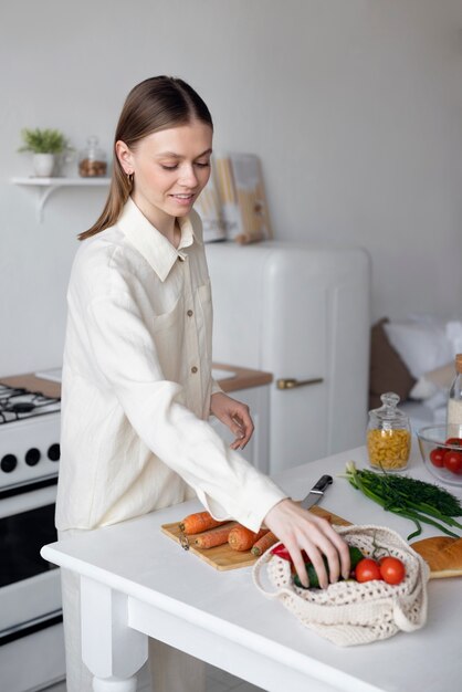 Side view woman with vegetables in kitchen