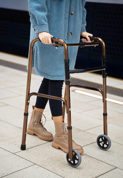 Free photo side view woman with walking frame