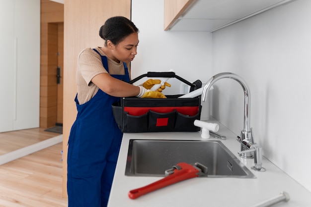 side view woman working as plumber