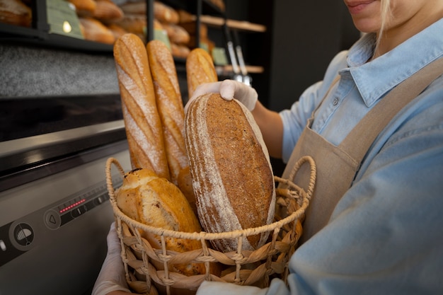 Free photo side view woman working in bakery