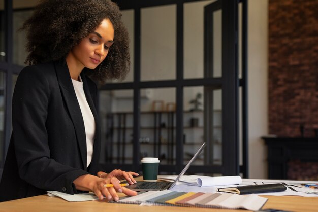 Side view woman working at desk