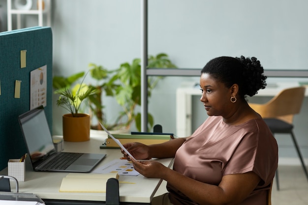 Side view woman working at desk