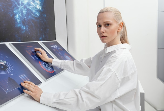 Free photo side view woman working on digital monitors