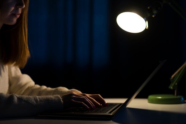 Side view of woman working on laptop