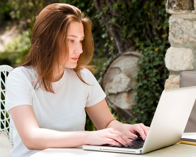 Side view of woman working on laptop