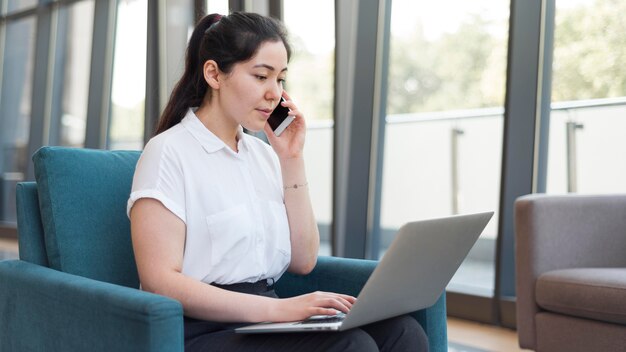 Side view woman working on laptop