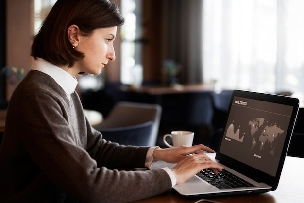 Side view woman working on laptop