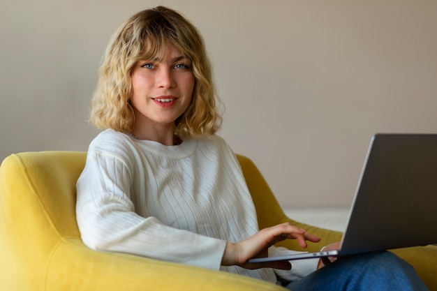 Side view woman working on laptop