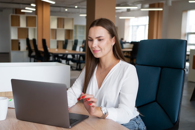 Side view woman working on laptop